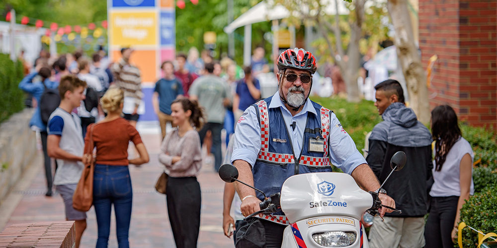 Security motorbike driving through around at Curtin Orientation Week