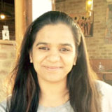 Curtin student, Simranjeet Kaur, looking at camera and smiling.