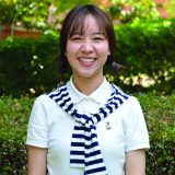 Curtin student Mojuan-Luo looking at camera and smiling