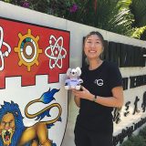 Curtin student, Lee Bing Tan holding a koala teddy and looking at camera and smiling