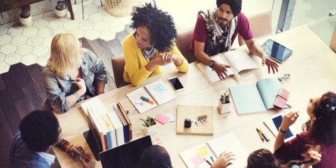 Aerial view of a group of people sitting around a conference table