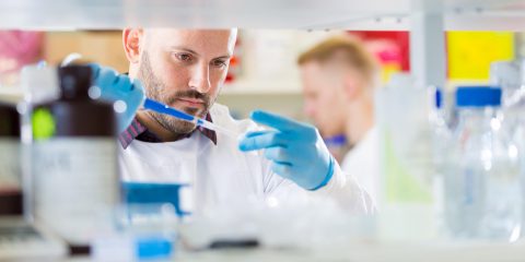 Male science researcher in lab conducting a test