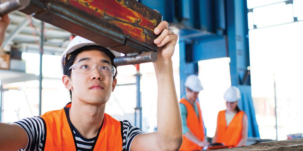 Construction student looking at metal frame